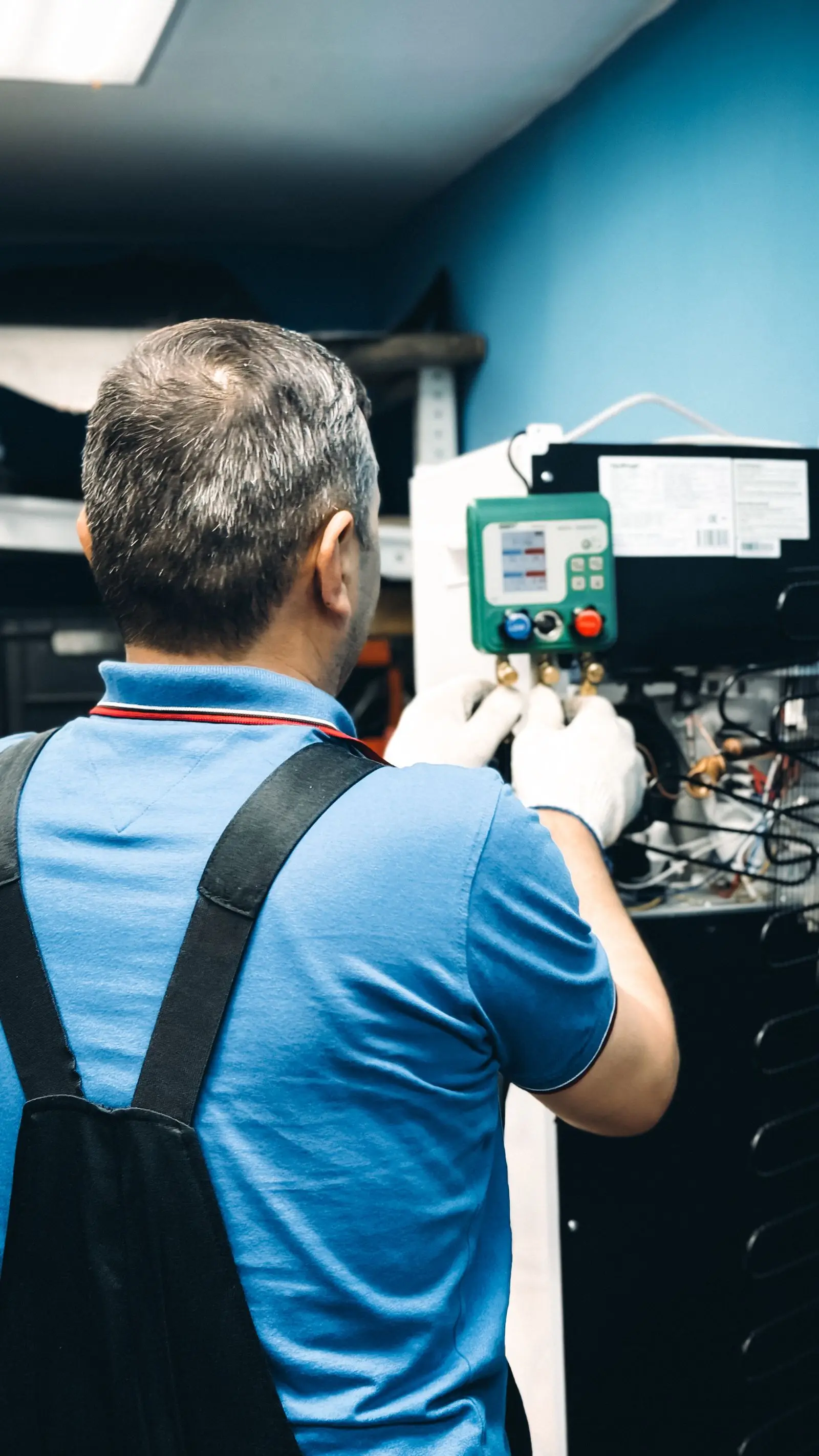 A technician working on indoor equipment
