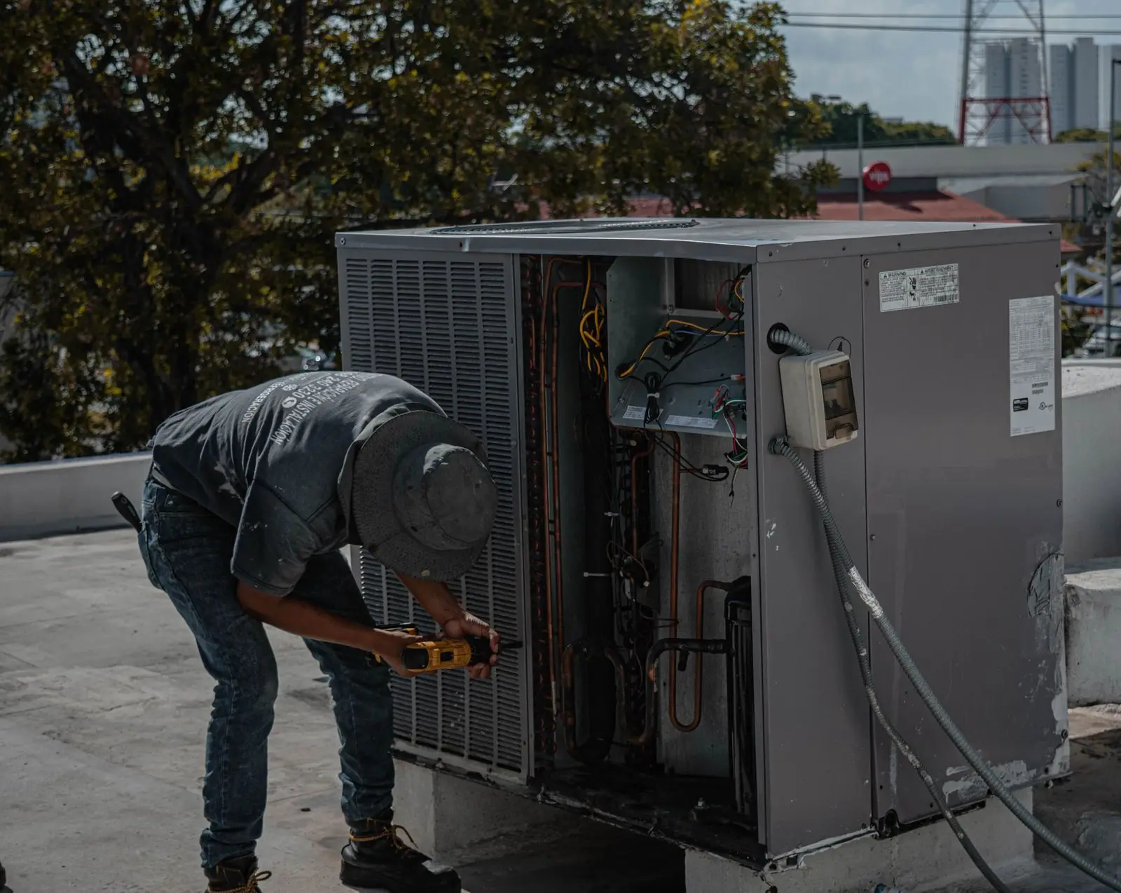 A technician servicing rooftop equipment