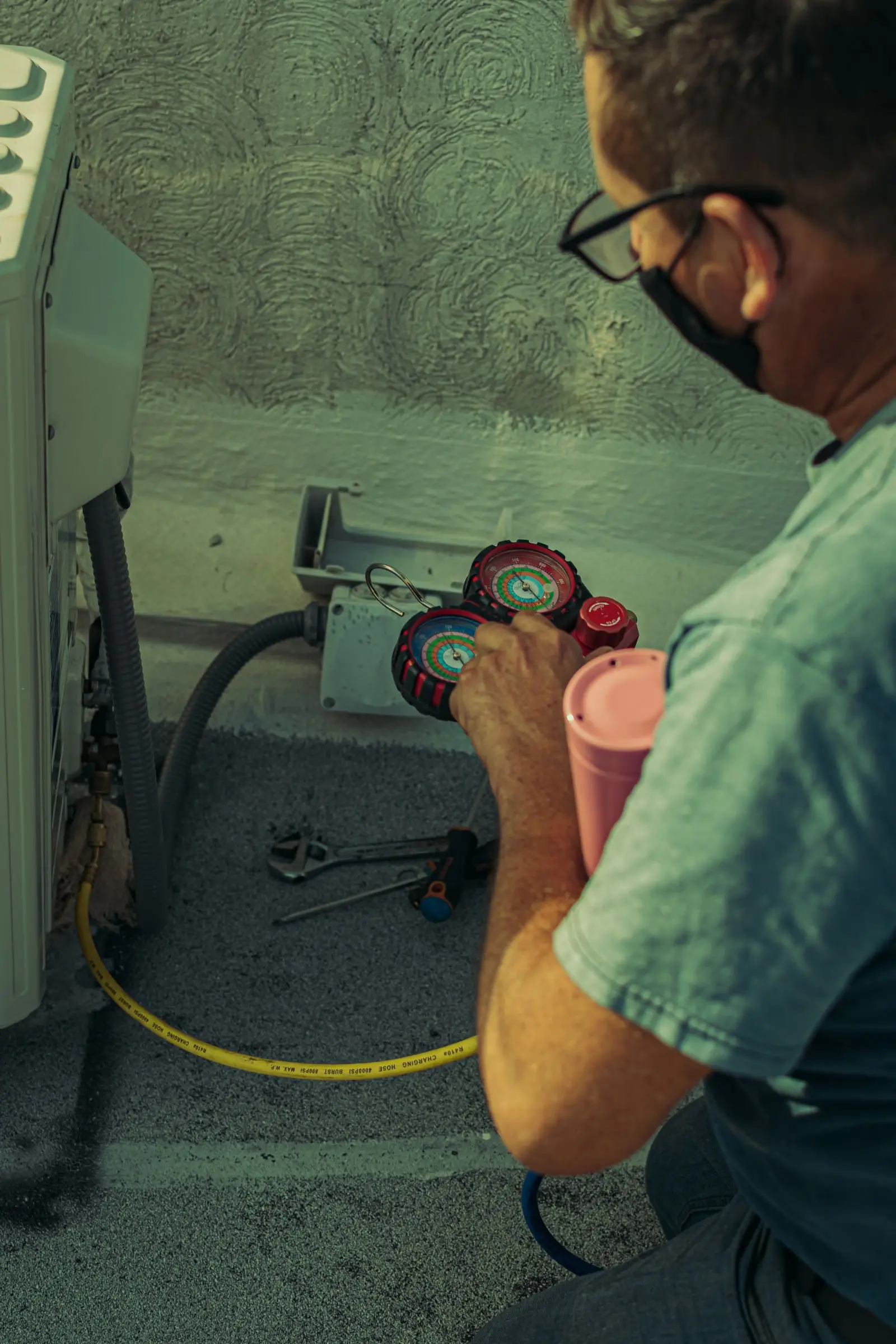 A technician working on indoor HVAC equipment